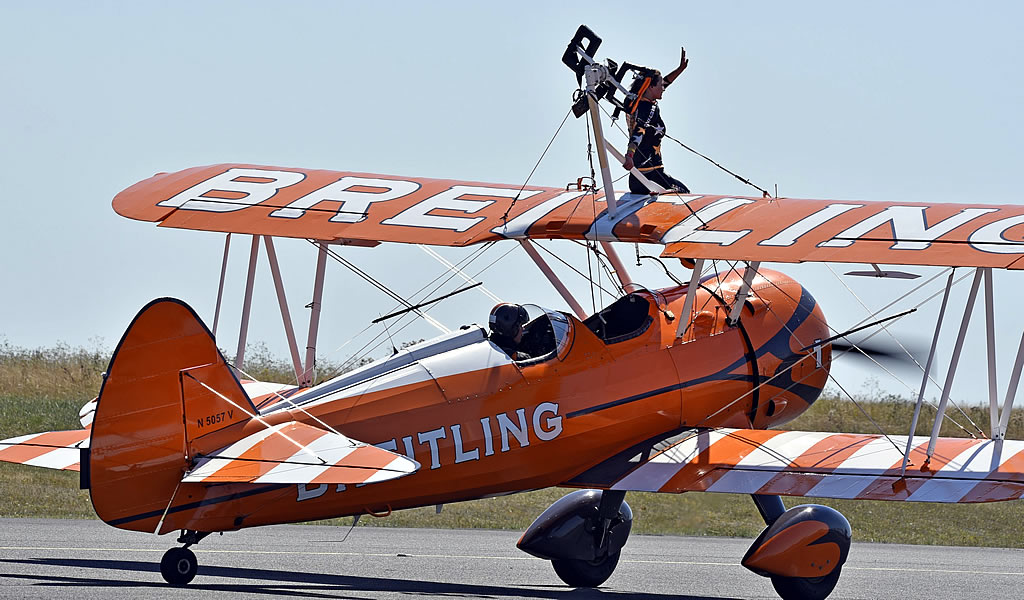 Breitling wing walker at an airshow on a Boeing Stearman Kaydet